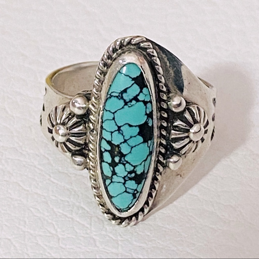 Adjustable Navajo designer stamped turquoise ring.